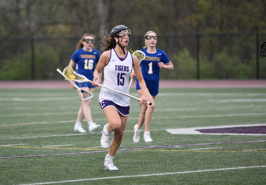 Cortland's Valerosa Gambitta runs up the field with the ball in her stick Tuesday at Cortland Junior-Senior High School. Gambitta recorded her 100th career point in the Purple Tigers' 18-11 loss.