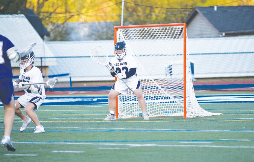 Homer's Ben Bradshaw watches the ball while manning the net Thursday night at Homer High School. Bradshaw made his 500th career save in the Trojans' 14-8 win.