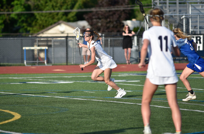 Homer's Izzy Tutino, center, breaks toward the goal off a restart Monday night at Homer High School. Tutino scored her firts goal of the season in the Trojans' 19-2 win over Watertown IHC in the first round of the Section III Class D tournament.