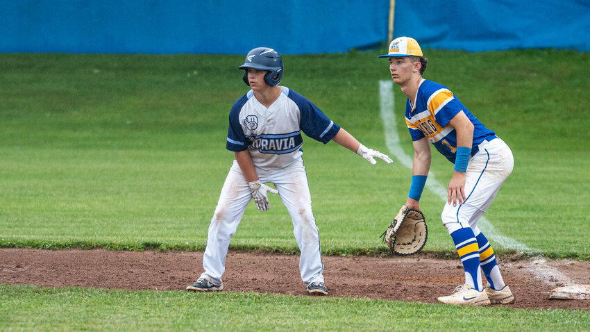 Moravia’s Thomas Palmer, left, leads off first base Wednesday at Trumansburg Central School.