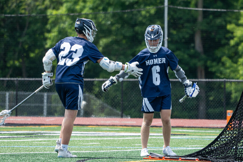 Homer's Chris Slade, left, and Daniel Stiles high five after a goal Saturday at Fayetteville-Manlius High School.