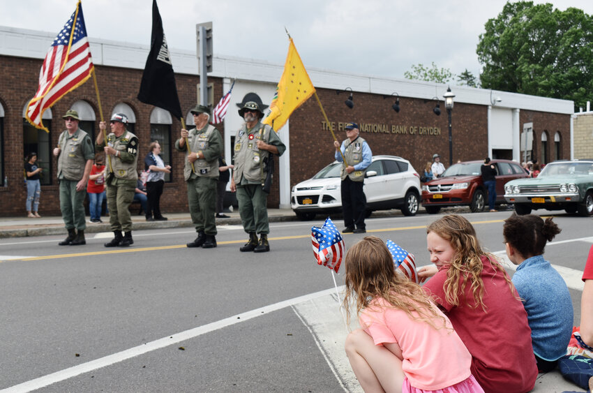 Children watch as Vietnam Veterans pass in parade in Dryden on Monday.