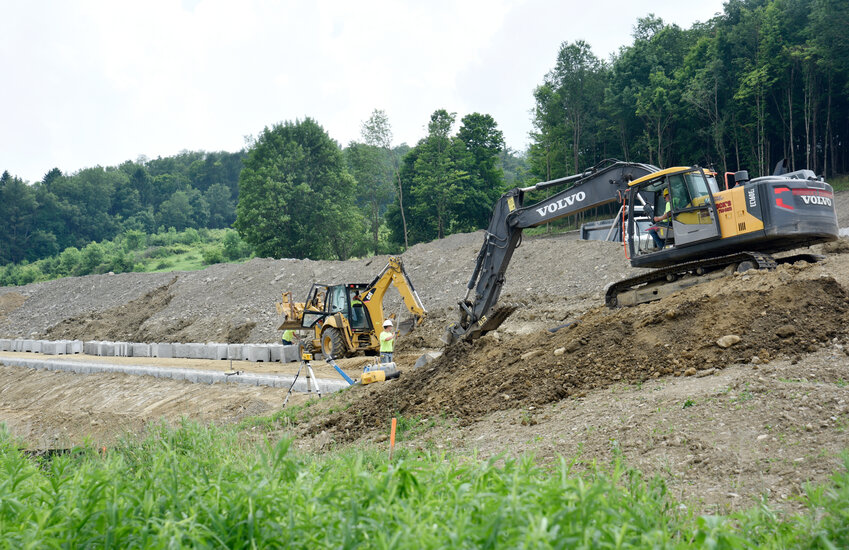 Murdock's Excavation crews construct a retaining wall Thursday behind the Family Health Network administration building on Route 281 in Homer. The hillside is being transformed to create a 12,000-square-foot medical facility to consolidate many of the services provided by the network.