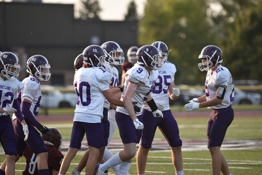 Cortland's Logan Toomey, No. 9, is picked up by teammates after a big hit on the opening kickoff Thursday night at Dana West High School. Toomey had a big night in Cortland's 54-14 win over Port Byron.