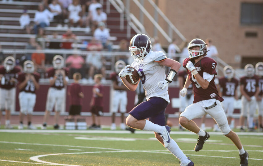 Cortland's Logan Toomey, center, breaks free for a long touchdown run Sept. 12 at Dana West High School.