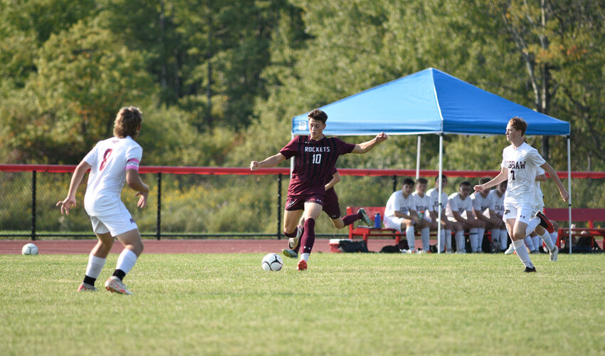 DeRuyter's Devens Whalen, center, prepares to send the ball across the field Friday at DeRuyter Central School. Whalen scored both goals in a 2-1 win.