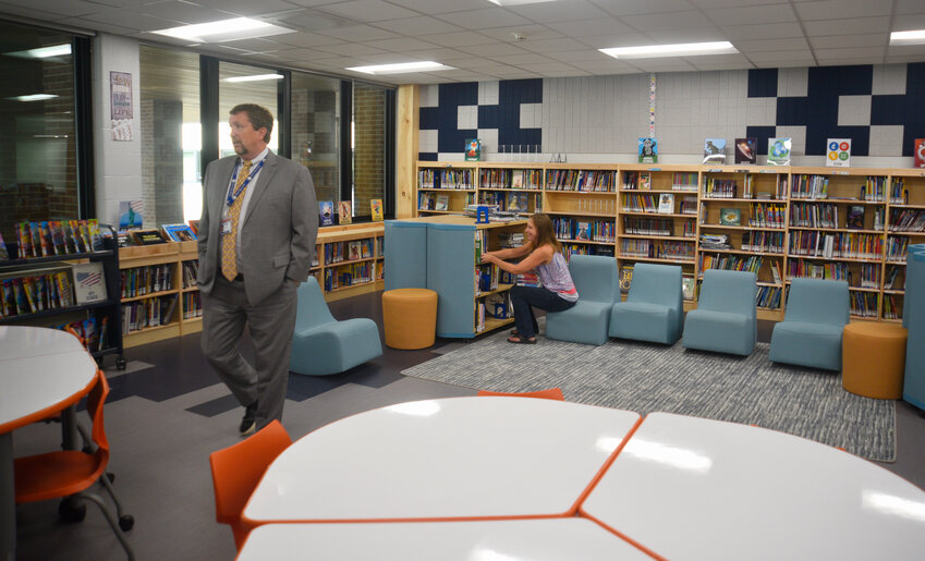 Homer Central School District Superintendent Thomas Turck, left, tours the Homer Intermediate School library as library media specialist is Katie Totman shelves books. The district has nearly completed a $26.4 million construction project that renovated several buildings and re-configured parking lots to improve safety.