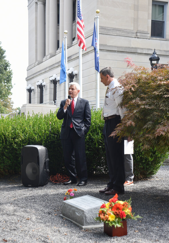 Supreme Court Justice Mark Masler and Don Armstrong dedicate a stone to former Cortland County Judge Emerson Avery Jr., who died in 2007. Avery, a Homer native, served as assistant district attorney, county public defender, and county judge from 1996 to 2003.