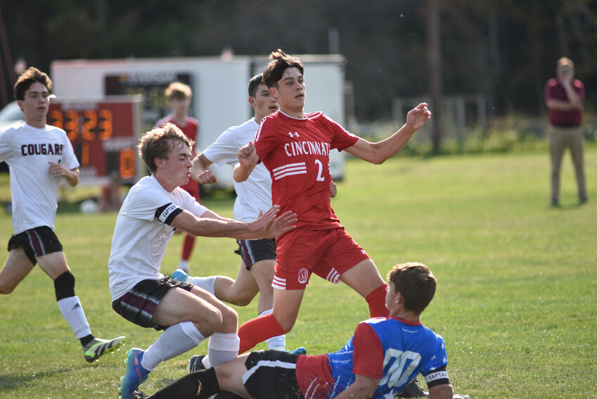 Cincinnatus' Jack Stafford, center, watches hit shot go in while surrounded by Stockbridge Valley/Morrisville-Eaton players Tuesday at Fireman's Field. Stafford scored twice in the Lions' 3-1 win.