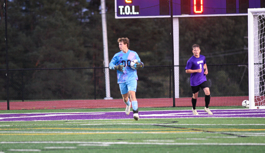 Dryden's Braden Allen, left, carries the ball to the top of the box Tuesday night at Dryden High School.