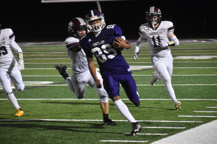 Cortland's Iniko Abani turns the corner to run down the sideline Thursday night at Cortland Jr./Sr. High School. Abani had a kickoff return touchdown to open the Purple Tigers' 44-34 win.