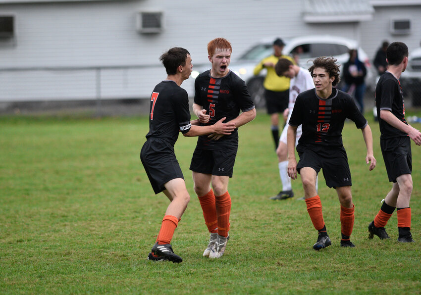 Marathon's Aydan Brown, center, celebrates with teammates Robert Anderson, left, and Nash Coleman, right, after beating Southern Cayuga 2-1 Wednesday at Marathon High School.