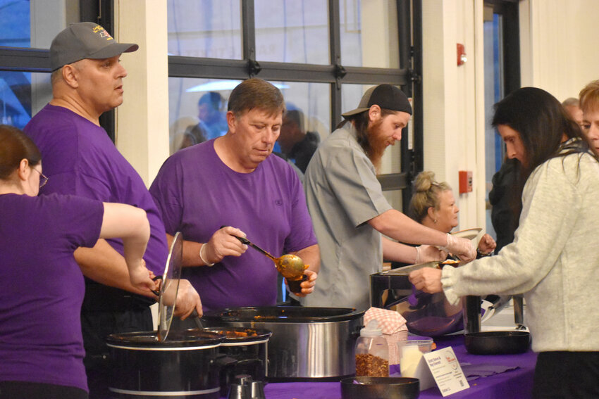 Scott Steve and Roy Everett of the City of Cortland Fire Department serve their two-alarm chicken riggies, which took home the award for Best Home Entree.