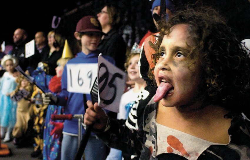 Miranda Smith, 7, sticks her tongue out to look scary during judging at a Halloween parade in 2014. A variety of events to mark the holiday are Friday, with more on the say until the end of the month.