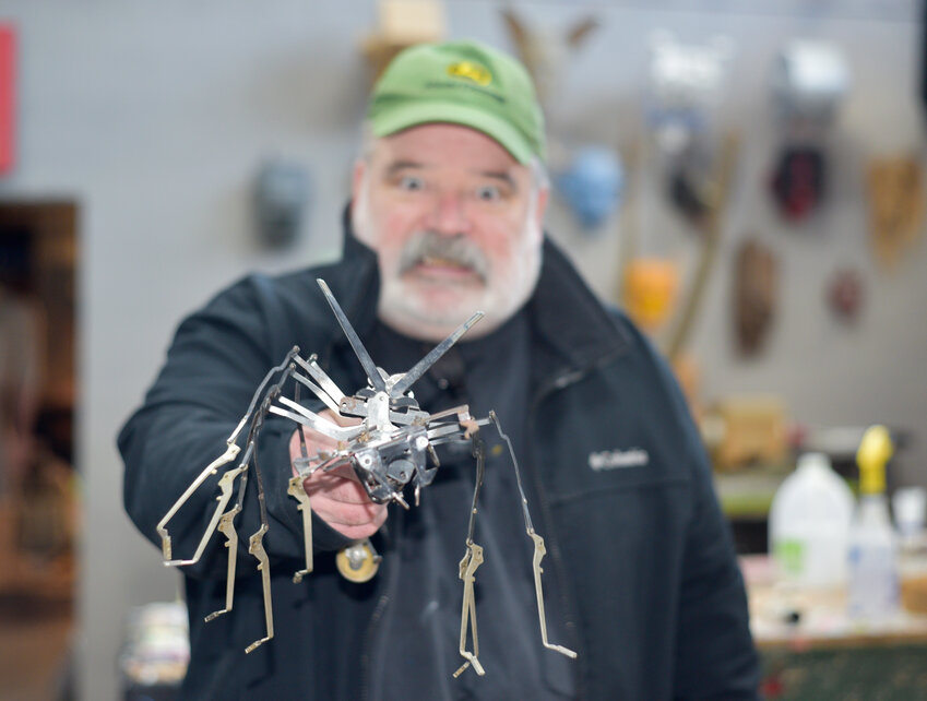 Paul Kozlowski, owner of the Ake Gallery in Cortland, holds his typewriter bug, one of the first things he ever made.