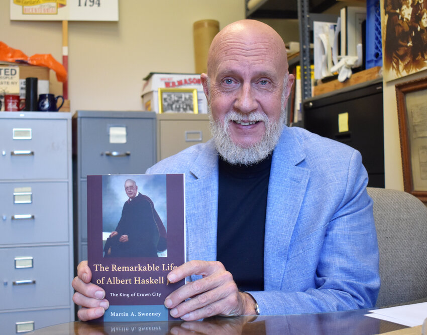 Homer Historian Martin Sweeney poses with his award-winning book 