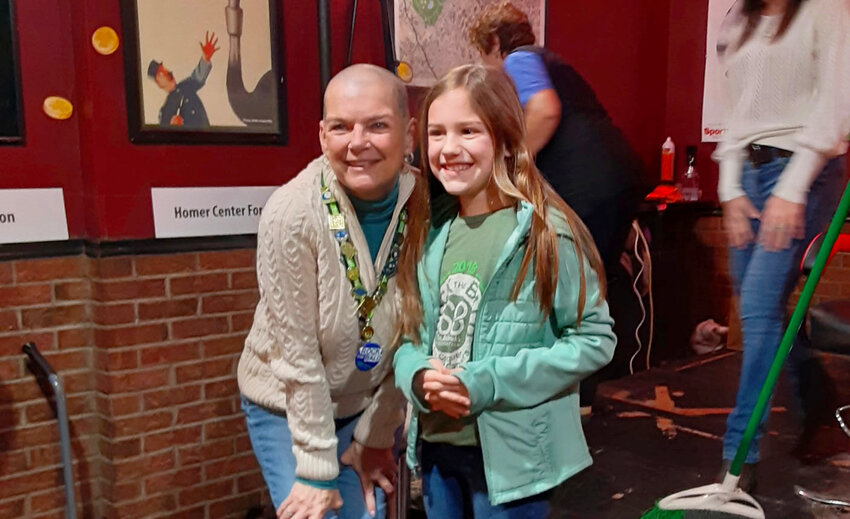 Alayah Green stands with Roxanne Davis just after she shaved Davis' head for St. Baldrick's Day in 2024 at the Red Jug Pub in Cortland.