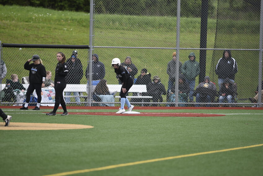 Moravia’s Emily Austin leads off third base Thursday night at Wells College.