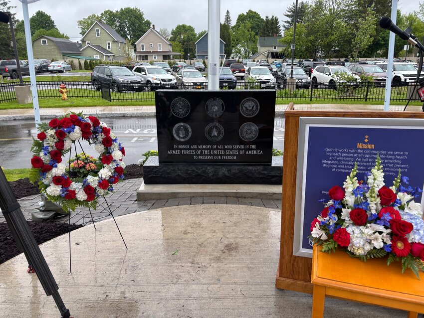 Guthrie Public Relations Manager Steve Osterhaus, right, speaks at a memorial dedication next to Jeff Grenzer, center, Friday at Guthrie Cortland Medical Center.