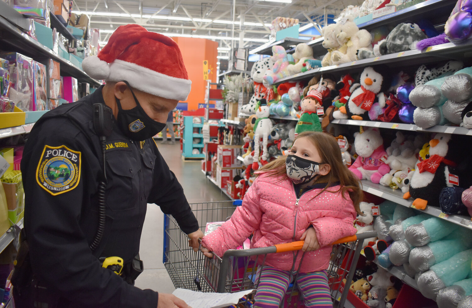 Cortland Deputy Chief David Guerrera helps Charlotte Mack, 6, of Cortland shop for Christmas presents in 2021 at Walmart in Cortlandville. Guerrera was named the city's next police chief Thursday.