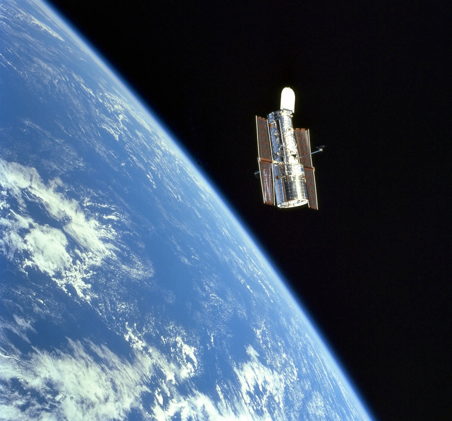 The Hubble Space Telescope floats in orbit in December 1999, as seen from the space shuttle Discovery.