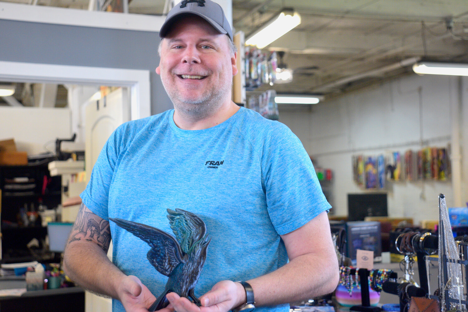 Area 51 owner Fran Crowe poses with a crow that he 3D-printed.