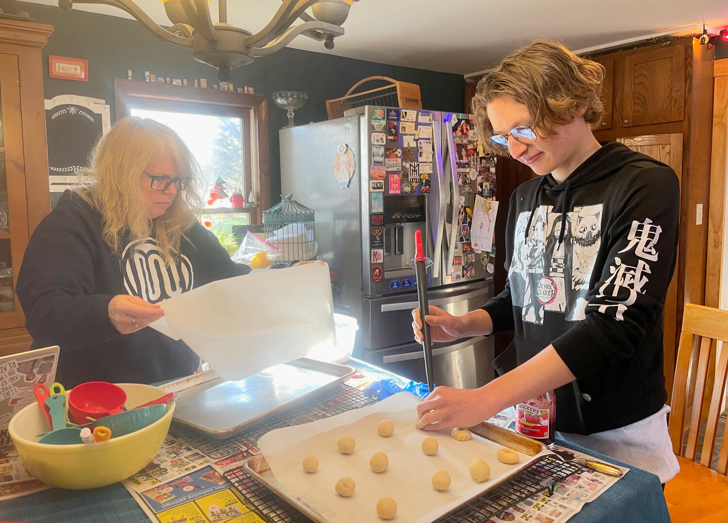 Reporter Lisa and Chase Byrne indent the dough for jelly cookies.