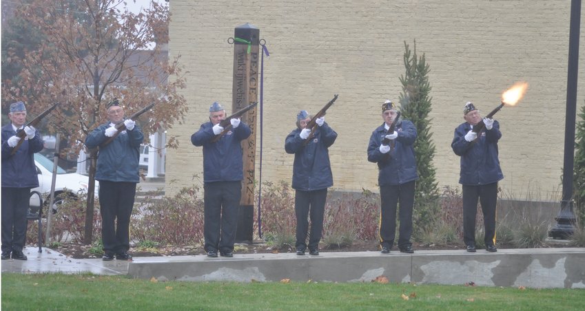Members of the Crawfordsville American Legion Byron Cox Post 72 Honor Guard conduct a 21-gun salute Monday during the community Veterans Day ceremony at Pike Place.