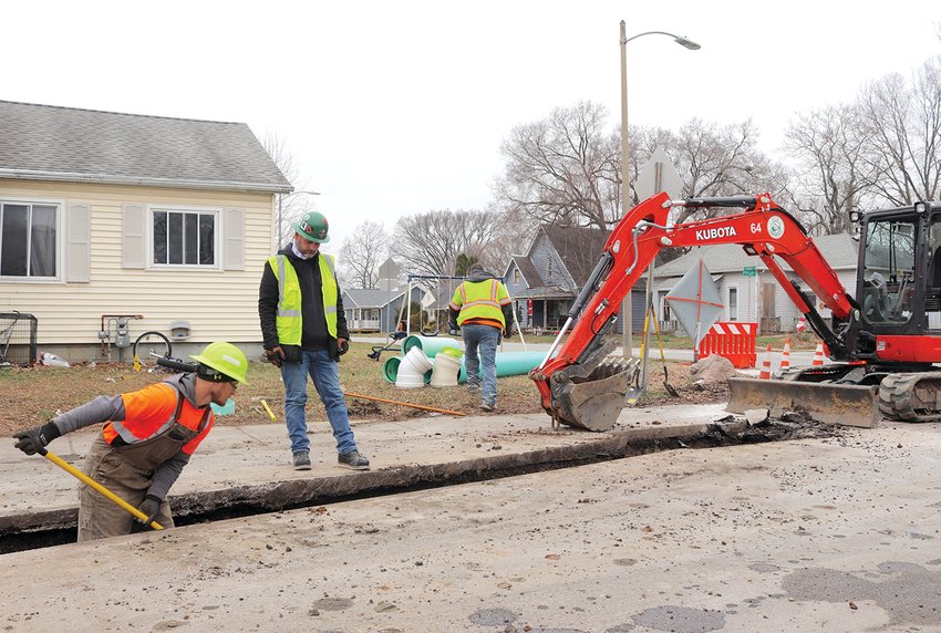 Street Department crew members Ed McGaughey, from left, stormwater foreman Chris Moore and Mick Selleck work to fix a drainage issue at West Market and Circle Drive Monday morning. Using a small backhoe loader, the workers installed large drainage pipes some four feet into historic layers of Crawfordsville's past. The project, set to wrap up by 2021, is the final effort of its kind for 2020 before crews head to the Northridge addition on the city's north side for further drainage imrpovements in January. Moore also took the time to make a public service announcement: If you have a driveway, park in it this winter to free up space for road work and snow plows, the latter of which Moore and his crew will be operating in the coming months.