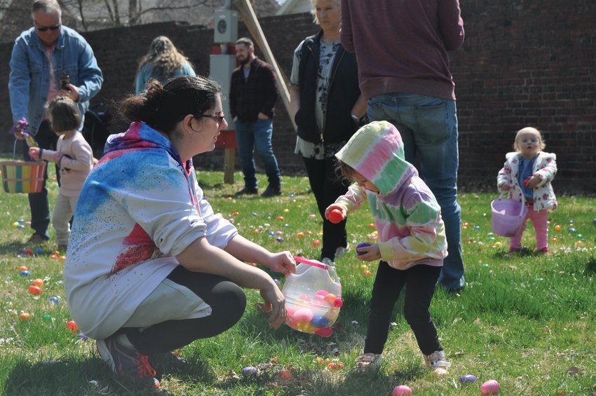 Tesslea Patton-Munn, 2, drops eggs in her basket held by mom, Jamie, at the Easter egg hunt on the grounds of the General Lew Wallace Study &amp; Museum Saturday. The event was sponsored by the Crawfordsville Parks and Recreation Department and Nucor Steel.