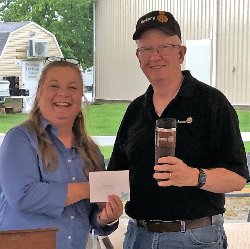 The Rockville Rotary Club recognized Greg Harbison (right) for his year of service as Rotary Club president.  A gift certificate to The Ranch restaurant and a Rotary coffee tumbler were presented by the new club president, Janna Scott, shown on the left.