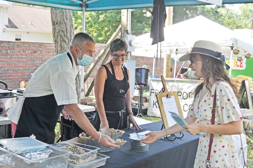 The Juniper Spoon serves salad to a customer at a previous Taste of Montgomery County on the grounds of the General Lew Wallace Study &amp; Museum.