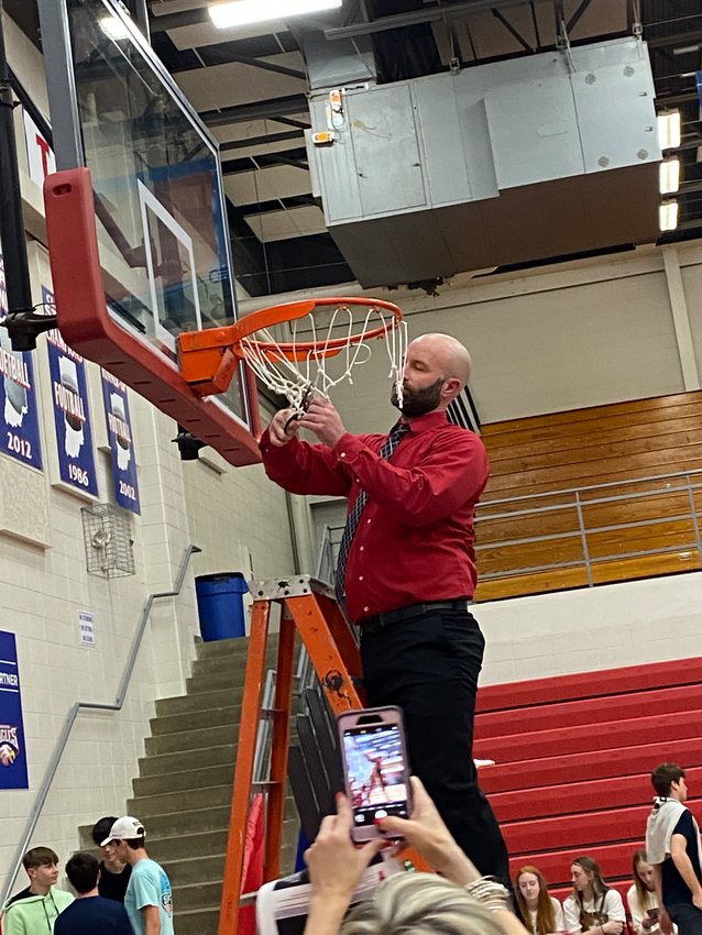 Jake Turner cuts down the nets after Southmont boys basketball captured the sectional championship last season. In six seasons he guided the Mounties to a 64-67 record and had a winning season each of the last three years.