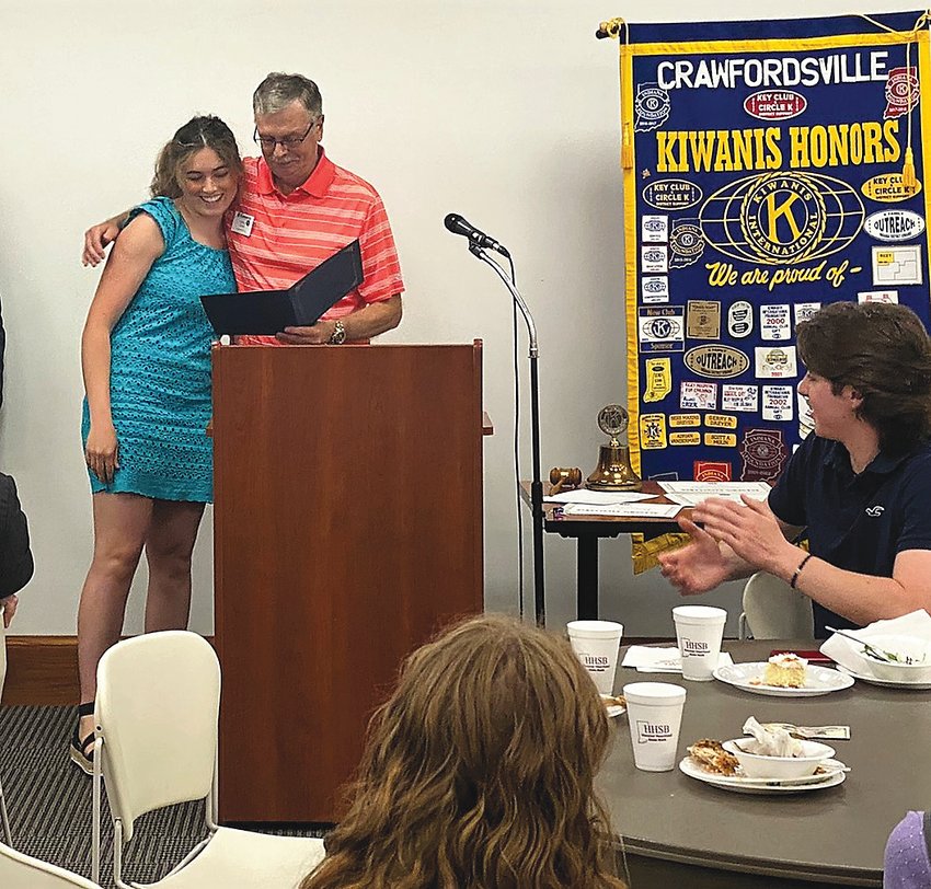 Dennis Coons, a Kiwanis member, presents a $1,000 scholarship Thursday from the local Kiwanis Club to his granddaughter, Hadley Broadwater.
