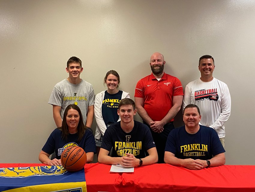 Southmont&rsquo;s Logan Oppy is pictured with his family and Southmont basketball head coach Jake Turner and assistant coach Dan Chadd.