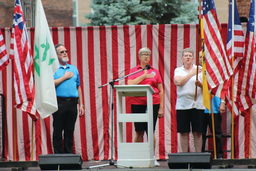 Members of the local Eagles Aerie conduct a flag ceremony and lead the crowd in the Pledge of Allegiance on Friday to open the annual Crawfordsville Strawberry Festival. The festival continues with live entertainment, food, arts and crafts and children&rsquo;s activities 11 a.m. to 10 p.m. Saturday and 11 a.m. to 4 p.m. Sunday at Lane Place, 212 S. Water St.