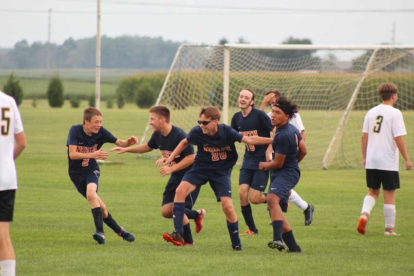 North Montgomery boys soccer celebrates with teammate Xavier Mantalvo (far right ) after his goal on   Saturday which gave the Chargers a 1-0 win over South Vermillion.
