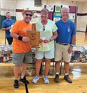 John and Jodi Curtis of Whiskey Whiskers BBQ   receiving cutting board trophy for winning Dessert category from event organizer Ken Schneider. Also pictured is the winning dessert,  Salted Caramel Cr&egrave;me Brule.