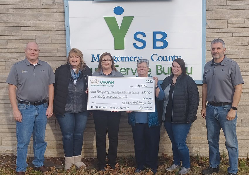 Crown Cork and Seal presented a $30,000 check Tuesday to the Montgomery County Youth Service Bureau alternative school. Pictured, from left, are James Monroe, Crown plant manager; Amy Cochran, YSB board member; Nikki Moore, Crown quality manager, Karen Branch, YSB executive director; Kashawndra Cooper, YSB board member and Kenneth Harshbarger, Crown HR manager.