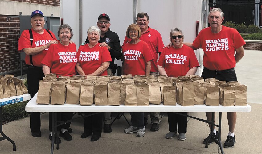 The Senior Adults Ministry Group, a ecumenical group from Woodland Heights Christian Church, passed out 119 bags of cookies for the Wabash College football team and coaches. The cookies were provided by Woodland Heights, First Baptist and Whitesville Christian Church. SAMS is open to all seniors. They have luncheons, game days, trips and LMU (Let's Meet up) fellowship gatherings. For information, call Pastor Steve at 217-294-1700 or email paststevehayes@msn.com. Pictured are Marianna Hayes, Connie Watson, Georgia Phelps, Fred Phelps, Walt Grant, Pastor Steve Hayes and Clay Watson.