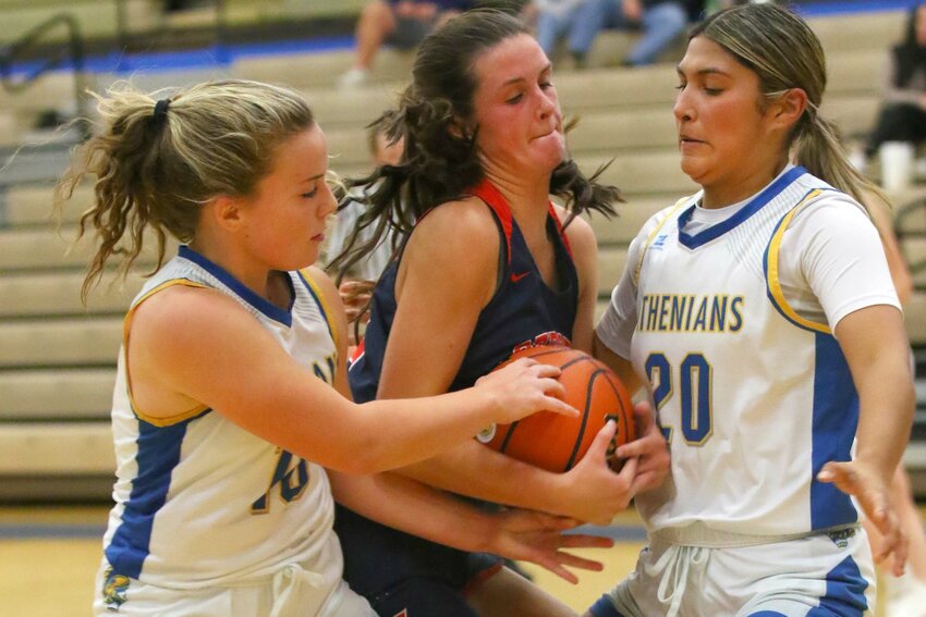 Molly Pierce of Crawfordsville - snatching the ball away from Addison Shrader of Seeger as Litzy Huesca closes in to help