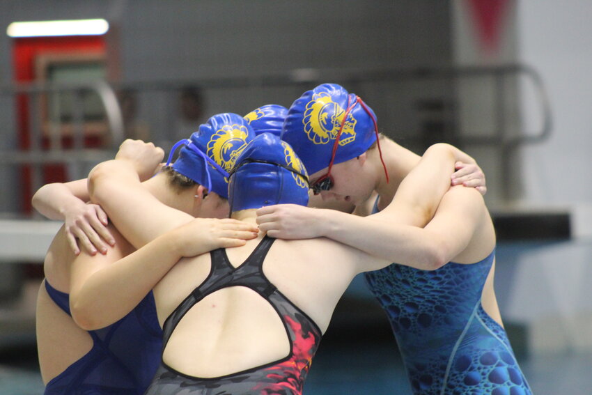 The Crawfordsville 200 medley relay team of Melanie Dowd, Ellie Walker, Marie Hesler, and Guinevere Schmitzer-Torbert share a moment together before their race at the IHSAA Girls Swim State Finals on Friday.