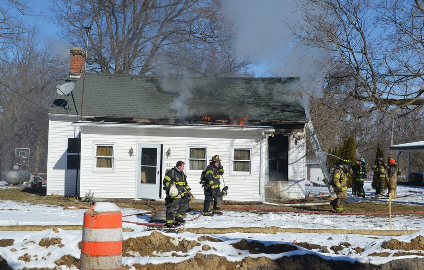 Firefighters extinguish a fire at 810 W. Main St. in Waveland on Monday.
