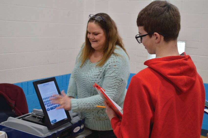 Montgomery County clerk Leah Denbo shows one interested student how the voting machines work and operate during the Reality fair on Monday. The fair was attended by nearly 500 eighth grade students from Southmont, Crawfordsville, and North Montgomery.