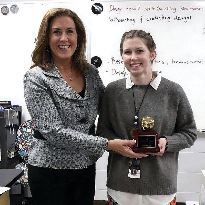 Parke Heritage Middle School science teacher Haley Roach, right,  has been named one of the Golden Apple Award winners by WTHI Channel 10 in Terre Haute. During one of her afternoon classes, Roach was surprised when there was a knock on her door and Patrece Dayton of Channel 10 entered her classroom and presented her the award. Roach was nominated for the award by sixth grade student Madilynn Schaefer. This nomination demonstrates the profound impact that Roach has on her students. ..The Golden Apple Award is highly selective, with only five educators from the Wabash Valley being honored each year.