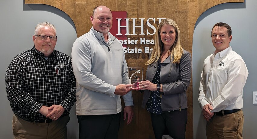 Displaying HHSB&rsquo;s Five Star Member award from the Indiana Bankers Association are, from left, HHSB&rsquo;s Trent Smaltz (CLO), Brad Monts (president and CEO) and Zach Hockersmith (CFO) with Amber Van Til (IBA president and CEO).