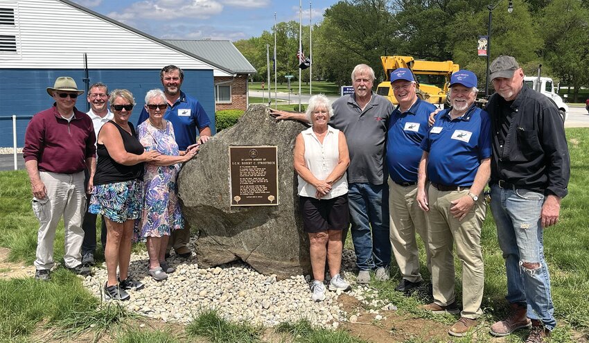 An eight-ton rock with a plaque honoring the memory of World War II and Vietnam War Veteran Robert Strodtbeck was recently installed at Veterans Memorial Park by VMP Advisor Roy Hurt of Craw-Con Inc. and Gail Blackwell of B&amp;L Engineering, who have contributed $10,000 to date through in-kind contributions to the park. It had been on display at a private residence in Greencastle. It was donated by Valerie Abernathy, Geraldine Payne and Linda Larkin, friends of Strodtbeck&rsquo;s daughter Helen. Pictured are VMP board secretary Bill Durbin, VMP board member John Douglas, donors Valerie Abernathy and Geraldine Pain, VMP board president Kevin Cobb, donor Linda Larkin, equipment operator Gail Blackwell, VMP board advisor Mark Eutsler, VMP board vice president Mike Spencer and VMP advisor Roy Hurt. VMP is organized as a not-for-profit corporation and is recognized as tax-exempt by the IRS under Section 501(c)(3). Its mission is &ldquo;Honoring All Veterans.&rdquo; Various parts of the park and its operation are available for sponsorship and underwriting, including purchasing bricks that will surround the center monument. Engraved bricks will recognize veterans and those who support veterans. More information is available on the park&rsquo;s Facebook page &mdash; Veterans Memorial Park &ndash; Crawfordsville.