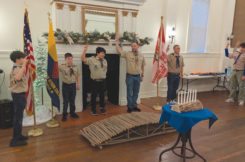 Members of Cub Scout Pack 909 opened the Blue and Gold banquet with a flag ceremony.