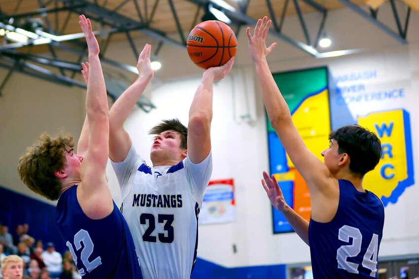 Noah Dodson of Fountain Central - getting off a short jumper between Ray Clayton (22) and Romeo Huerta of Lafatette Central Catholic