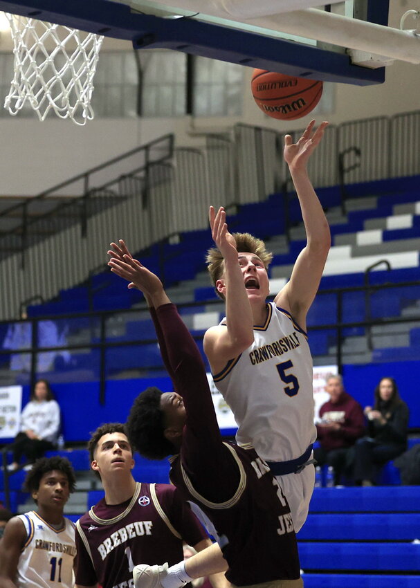Athenian Mason McCarty heads to the hoop on Wednesday against Brebeuf. The junior put up 16 points in the sectional opener at Frankfort.